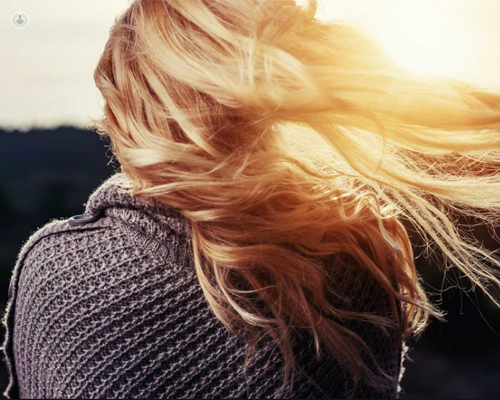 Chica con cabello sano al viento - caída de cabello y salud capilar by Top Doctors