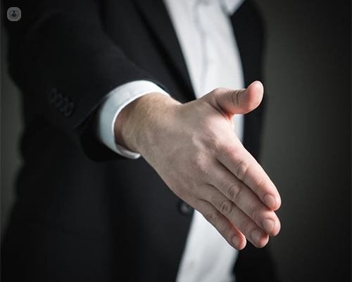 Hombre ofreciendo la mano para saludar a alguien- hiperhidrosis by Top Doctors